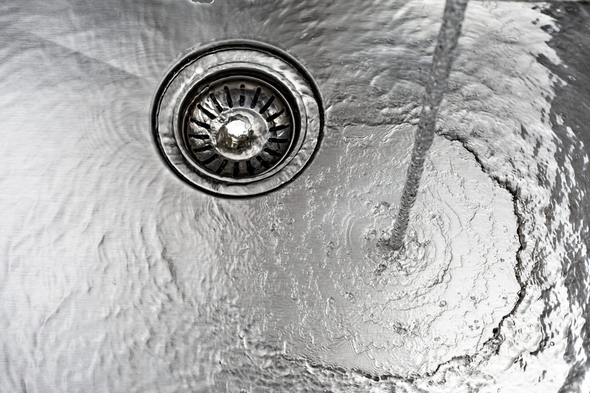 Water flowing into a clogged sink drain