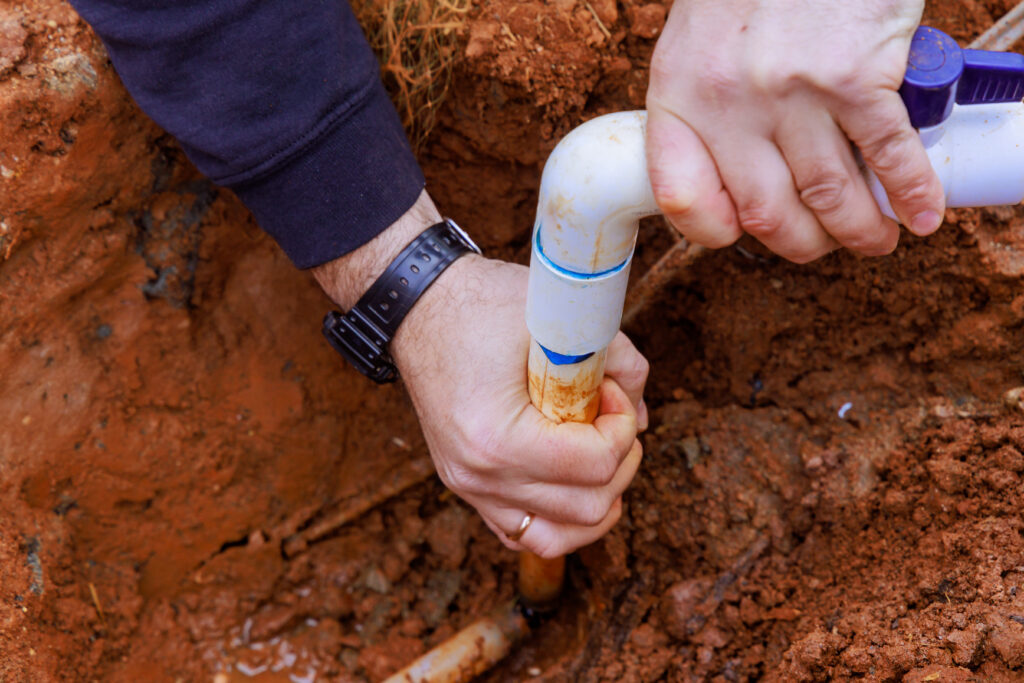 Plumber repairing an underground pipe