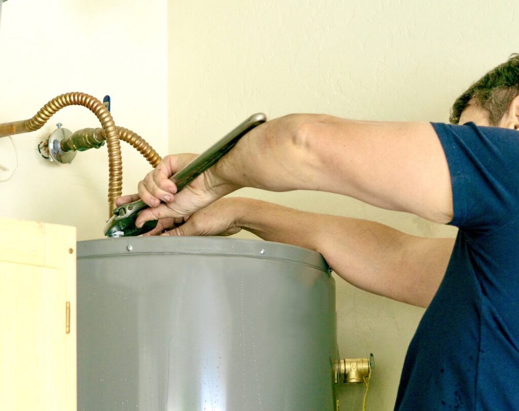 Technician repairing a residential water heater